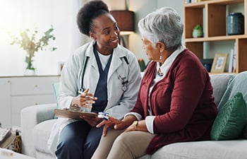 A healthcare professional assisting an elderly person.