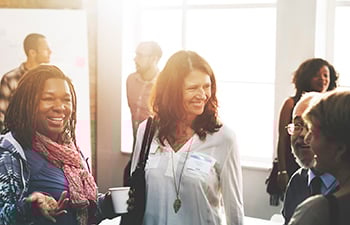 A group of adults meeting at a community event.